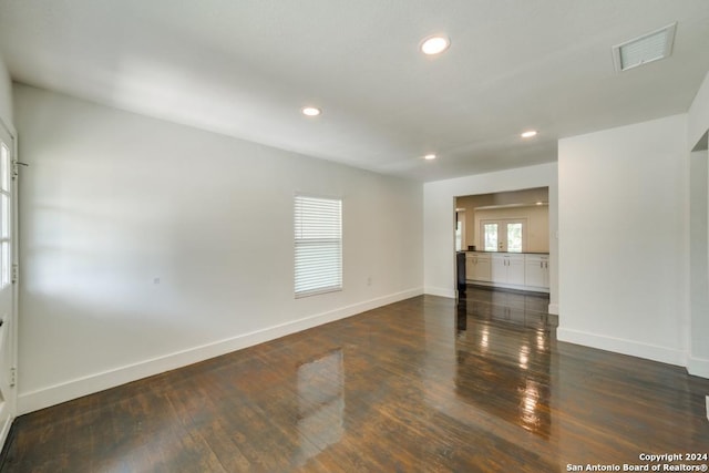 unfurnished room featuring dark wood-type flooring