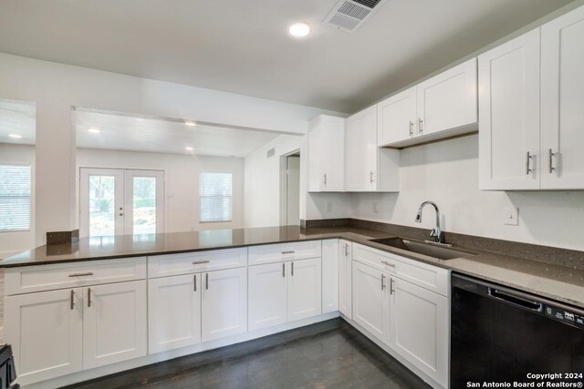 kitchen with dark stone counters, sink, black dishwasher, and white cabinetry