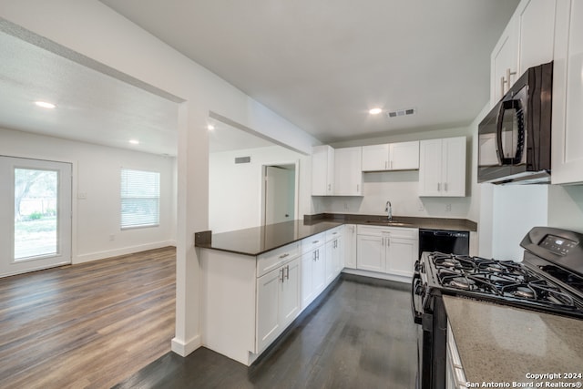 kitchen featuring white cabinetry, sink, dark hardwood / wood-style flooring, and black appliances