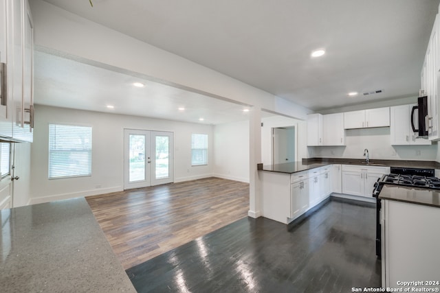 kitchen featuring white cabinets, sink, dark wood-type flooring, and french doors