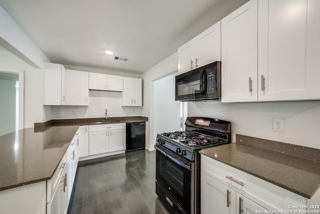 kitchen with sink, black appliances, dark hardwood / wood-style flooring, dark stone counters, and white cabinets