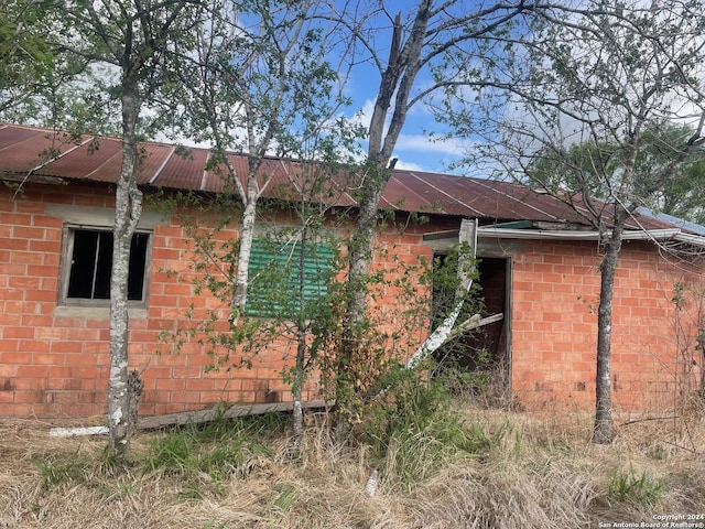 view of property exterior featuring brick siding