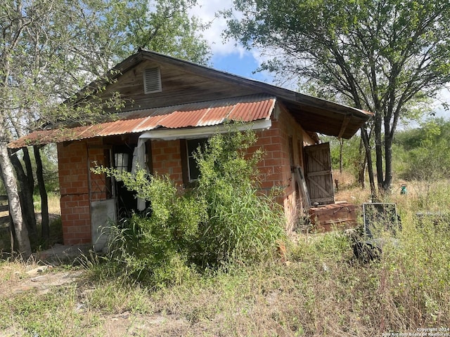 view of side of property featuring metal roof