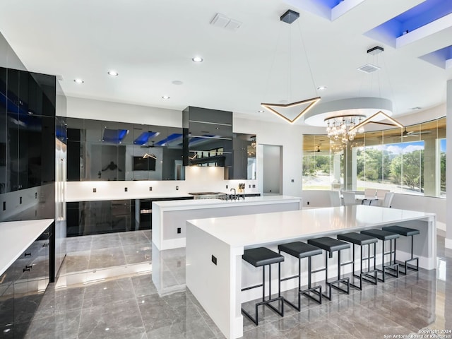 kitchen with decorative light fixtures, a chandelier, a large island, sink, and light tile patterned floors