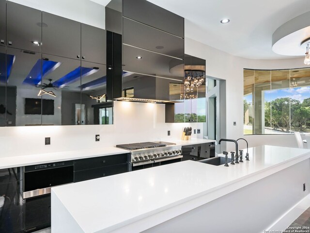 kitchen featuring backsplash, a kitchen island, range with two ovens, wall oven, and sink