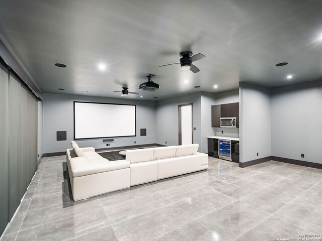 cinema with light tile patterned floors, ceiling fan, and beverage cooler