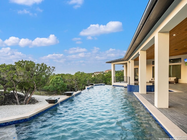 view of swimming pool with a patio area and pool water feature