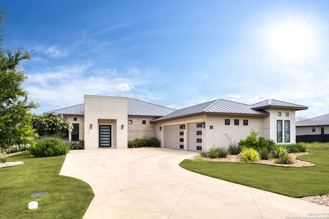 view of front of house featuring a garage and a front yard