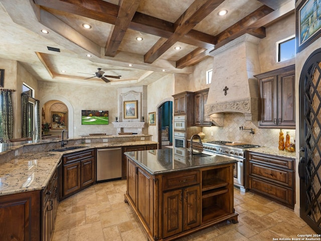 kitchen with a center island with sink, appliances with stainless steel finishes, light tile flooring, ceiling fan, and custom exhaust hood