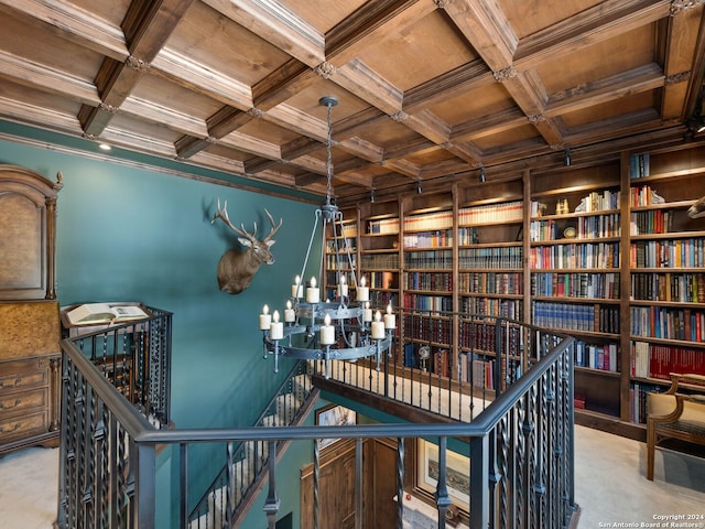 unfurnished office with coffered ceiling, ornamental molding, carpet, and wooden ceiling