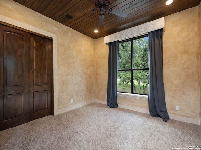 unfurnished bedroom with carpet floors, wood ceiling, and ceiling fan