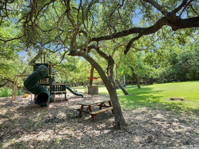 exterior space with a playground and a lawn