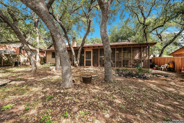 rear view of house featuring a sunroom