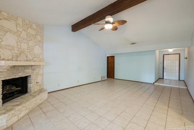 unfurnished living room with lofted ceiling with beams, a stone fireplace, ceiling fan, light tile patterned floors, and a textured ceiling