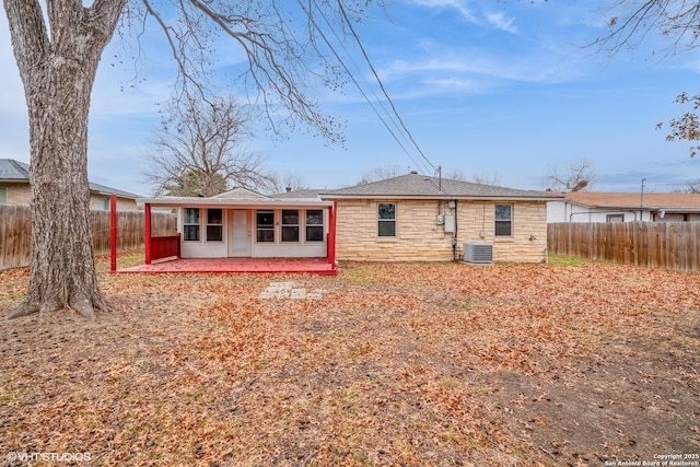 rear view of house with central AC unit and a patio