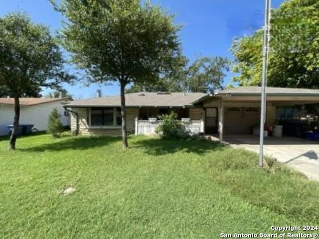 ranch-style house with a front yard and a carport