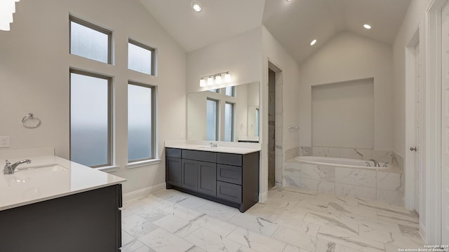 bathroom featuring vanity, tiled bath, and high vaulted ceiling