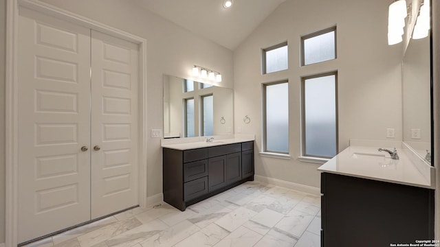 bathroom with vanity and vaulted ceiling