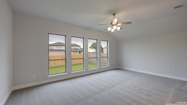 carpeted empty room featuring ceiling fan and vaulted ceiling