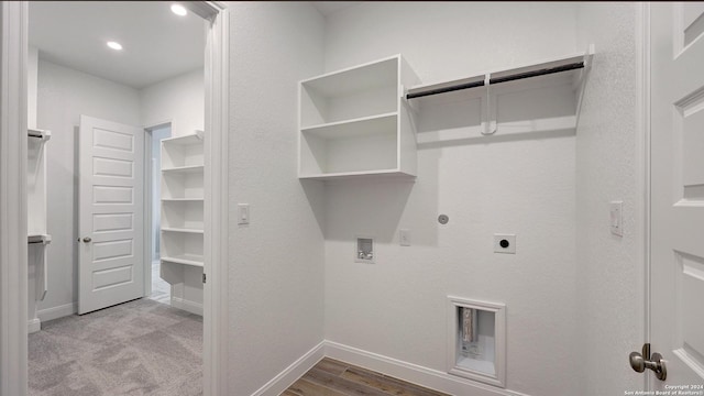 laundry area featuring gas dryer hookup, light hardwood / wood-style floors, washer hookup, and hookup for an electric dryer