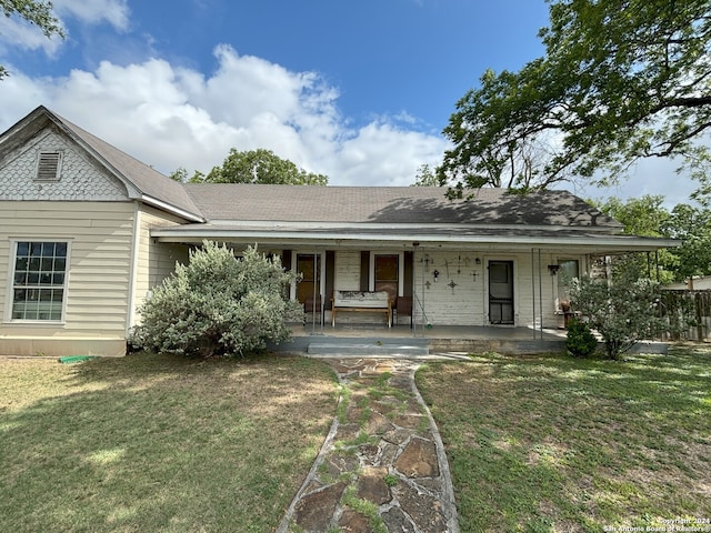 view of front of home with a front yard and a porch