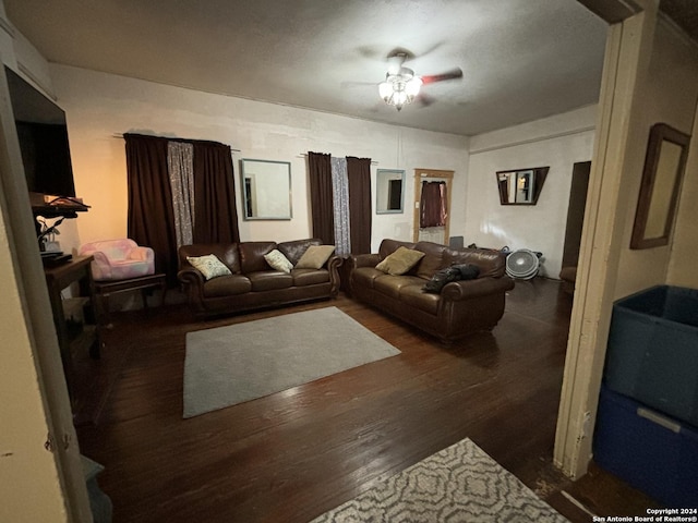 living room with dark wood-type flooring and ceiling fan