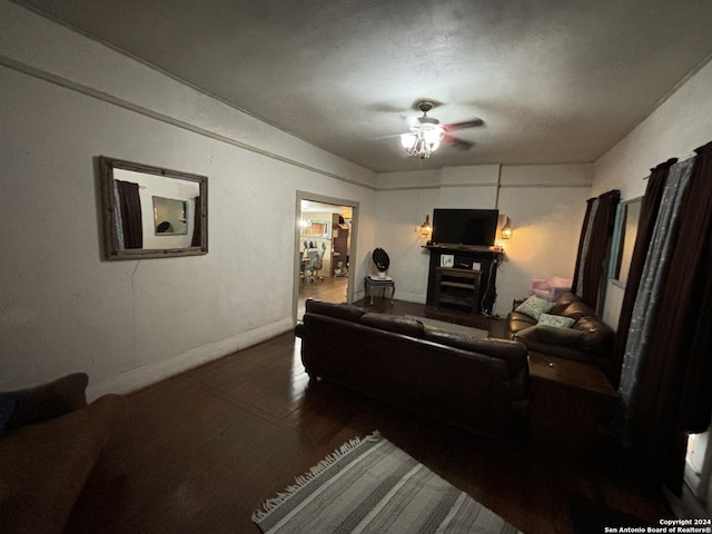 living room featuring dark hardwood / wood-style flooring and ceiling fan