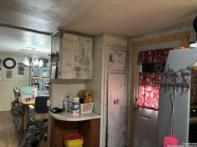 kitchen featuring an inviting chandelier and wood-type flooring