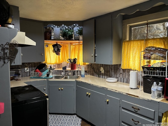 kitchen with gray cabinets, tasteful backsplash, black electric range oven, and a textured ceiling