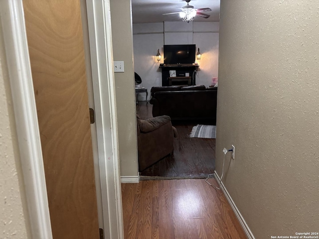 hallway with hardwood / wood-style floors