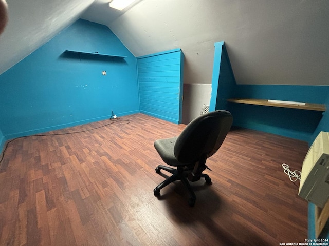 unfurnished office featuring vaulted ceiling and hardwood / wood-style floors