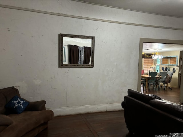 living room featuring dark wood-type flooring and a chandelier