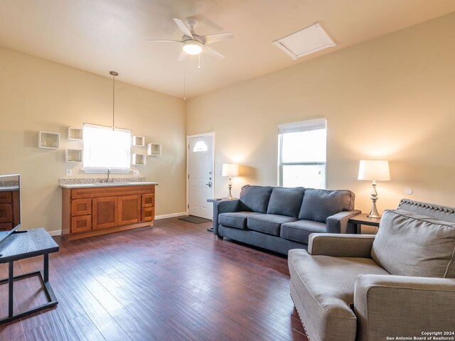 living room with ceiling fan and dark hardwood / wood-style floors