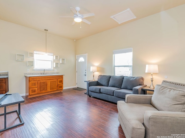 living room featuring sink, dark wood-type flooring, and ceiling fan