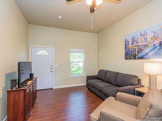 living room featuring ceiling fan and dark hardwood / wood-style flooring