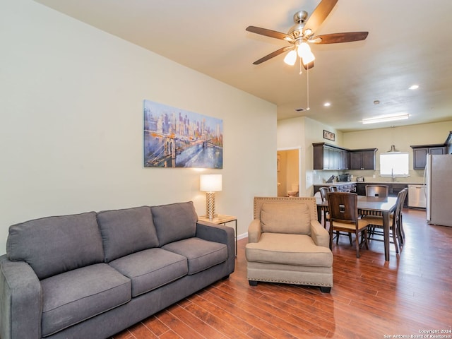 living room with hardwood / wood-style flooring and ceiling fan