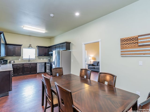 dining space with sink and dark hardwood / wood-style flooring