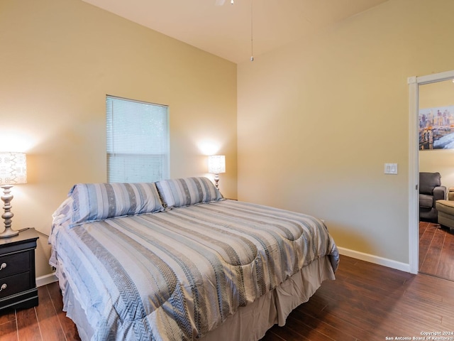 bedroom with dark hardwood / wood-style floors