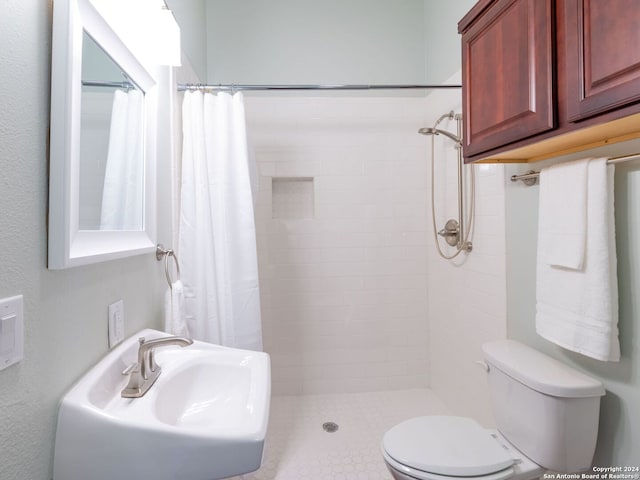 bathroom featuring walk in shower, sink, toilet, and tile floors