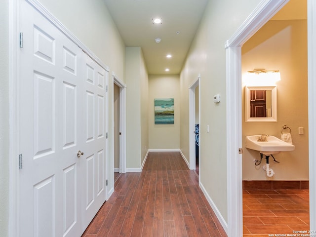 hall with dark wood-type flooring and sink