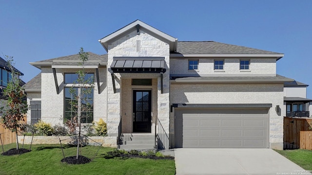 view of front of house with a front yard and a garage