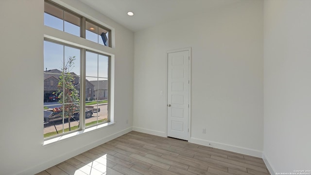 spare room with light hardwood / wood-style flooring