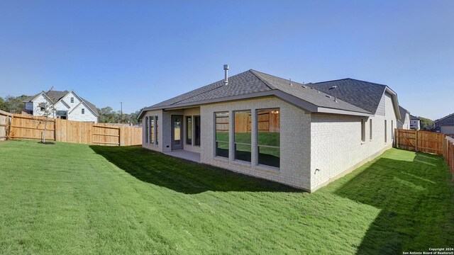 rear view of house with a lawn