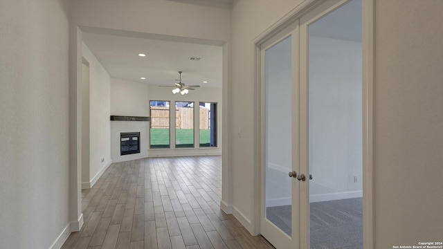 corridor with light hardwood / wood-style flooring