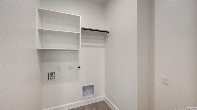 laundry room with hookup for an electric dryer, hookup for a washing machine, gas dryer hookup, and hardwood / wood-style flooring