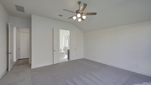 unfurnished bedroom with ceiling fan, light colored carpet, and vaulted ceiling