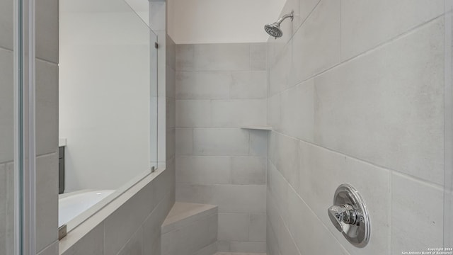 bathroom with tiled shower