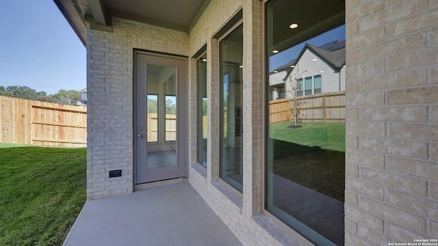 doorway to property featuring a yard and a patio area