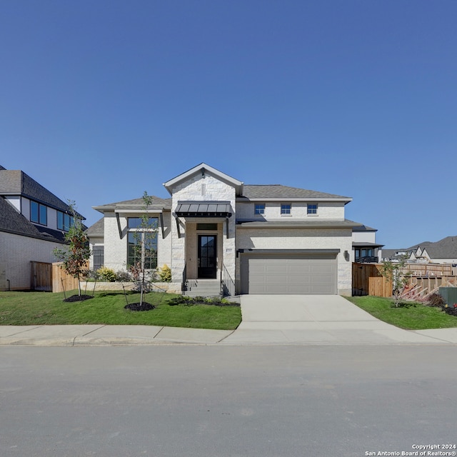 prairie-style house with a front lawn