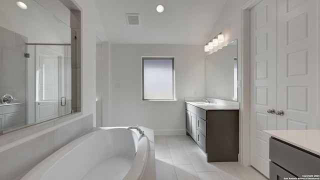 bathroom with tile patterned floors, vanity, and independent shower and bath